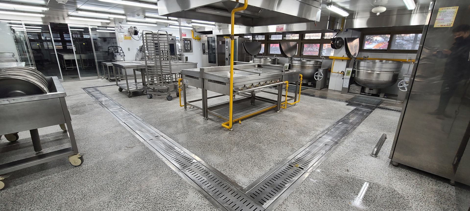 Commercial kitchen floor with stainless trench drains